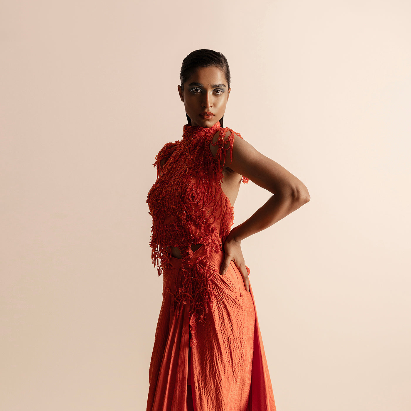 side view of Women's 3D embellished halter blouse with sculpted texture draped skirt in hot orange - couture orange look, ruched skirt, sculptural embroidery, evening set