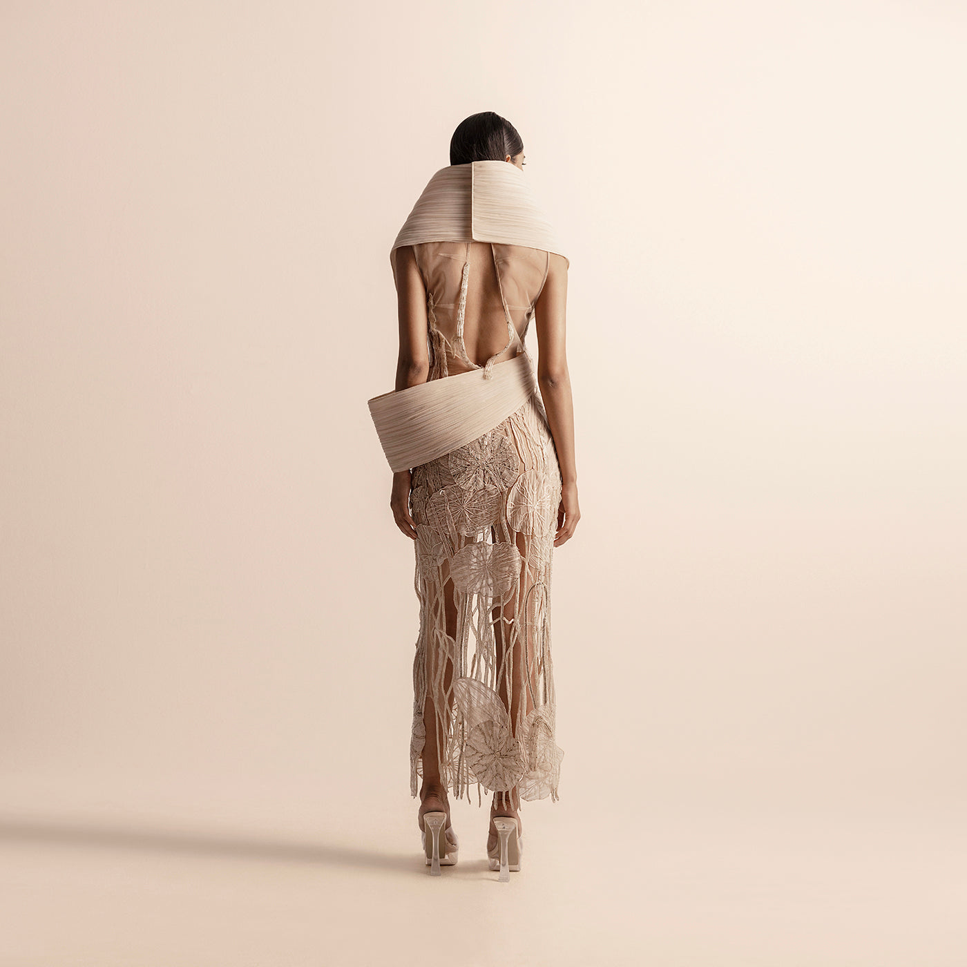 Back view of sculpted pleated top and 3D embellished skirt set – sculpted top back, 3D embellished skirt, futuristic fashion,, 