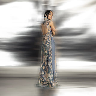 full back view of Women's backless reef-embroidered high neck jacket over blue pants – intricate sleeveless couture outerwear