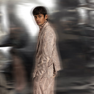 Shawl collar jacket embellished with graphic yarn couching in a linear pattern. The jacket is paired with matching wide hem yarn couching detailed trousers. A high-collar shirt in reef print makes a perfect ensemble for special occasions.  #abhisheksharma #fashiondesignerabhisheksharma #reef #redcarpet #shortdress #abhishekstudio #lfw #fdci 