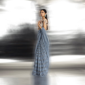 Net saree embellished with fine Resham and beadwork in linear design. The 3D embellished blouse imparts an elegant blend of modernity and tradition.  #abhisheksharma #fashiondesignerabhisheksharma #reef #redcarpet #shortdress #abhishekstudio 