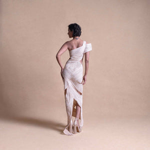 Back view of asymmetrical cream dress with layered wrap panels and cutout details – creative fashion design, fitted dress, resort wear