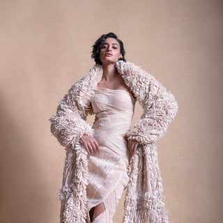 Model in sculptural cream wrap dress and voluminous textured coat – modern high-fashion layering