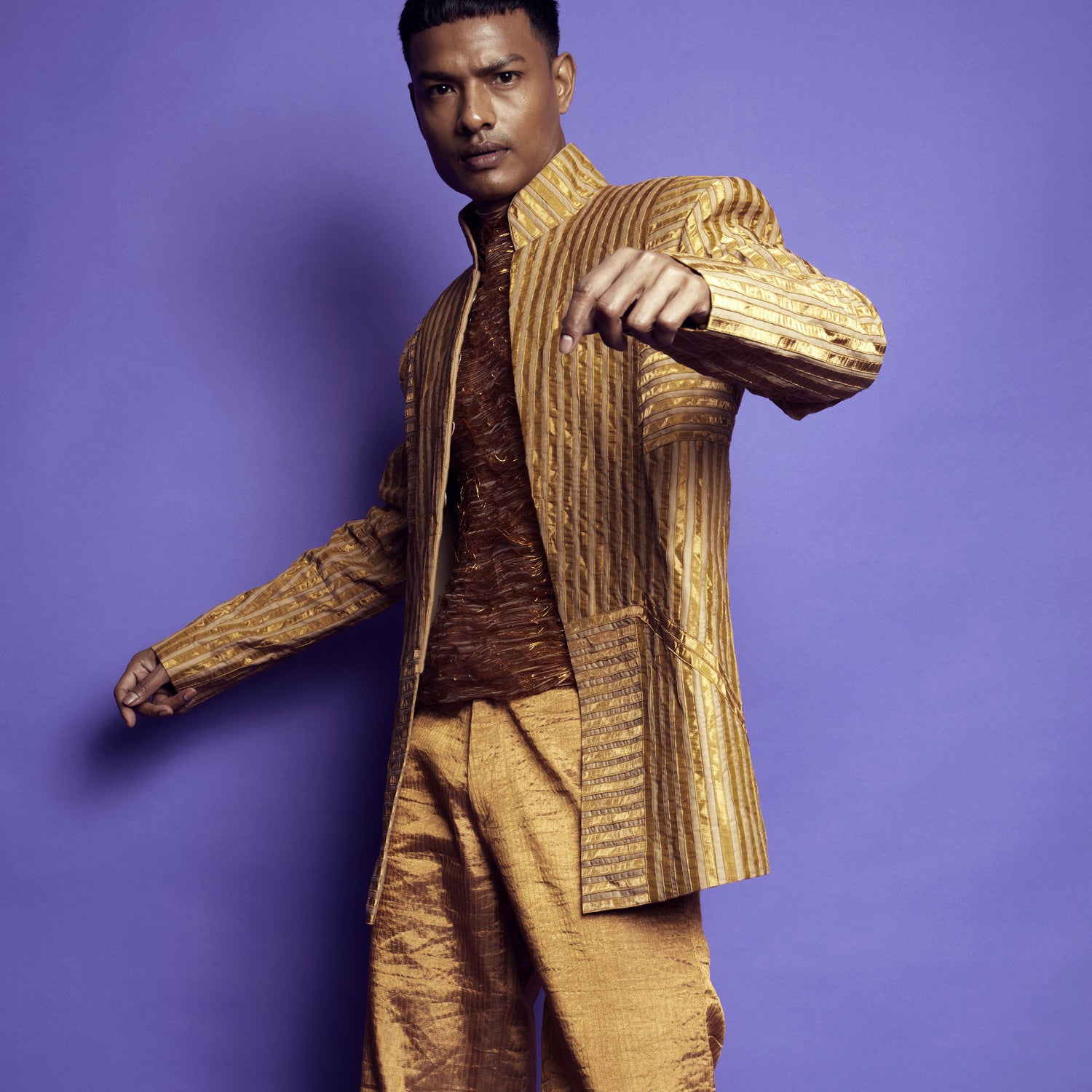 Man in gold textured Bandhgala suit with metallic shirt and matching trousers - Tuxedo, retro suit, menswear