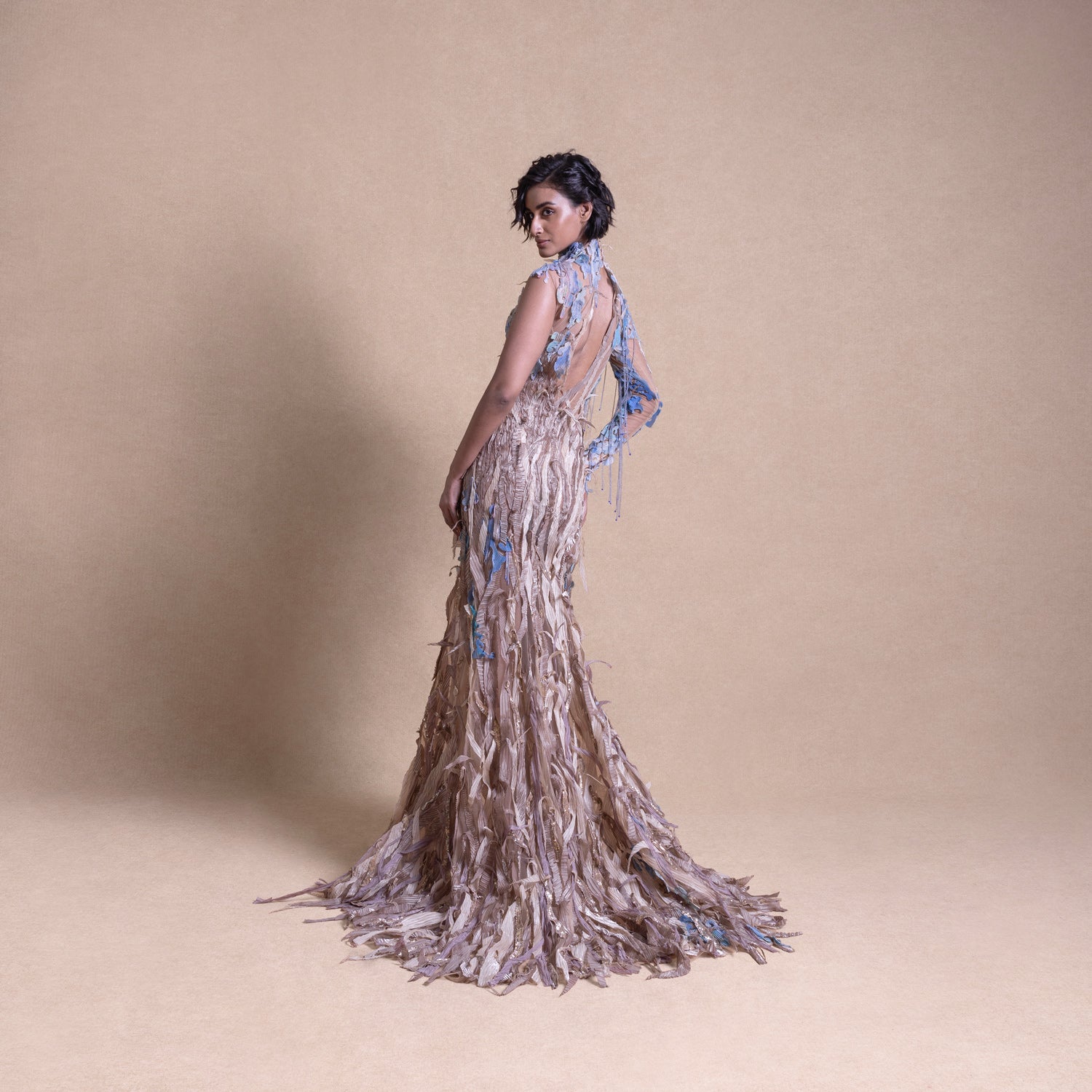 back view of model in earth-toned couture gown with blue embroidered details and open back - eco-luxury fashion, reception gown, backless evening gown,