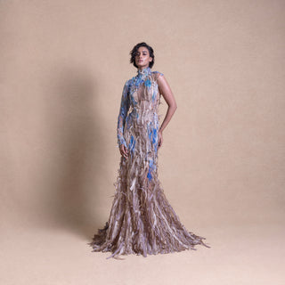 Model in eco-luxury gown inspired by crop fields with blue floral accents on neutral studio backdrop - eco-luxury fashion, reception gown