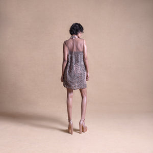 Back view of a sleeveless embroidered mini dress featuring a sheer overlay - artistic high fashion outfit, youngester dress, luxury womenswear