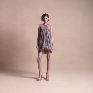 Front view of a model wearing a sleeveless, sheer balloon mini dress with a softly pleated silhouette in neutral tones - artistic high fashion outfit, youngester dress, luxury womenswear