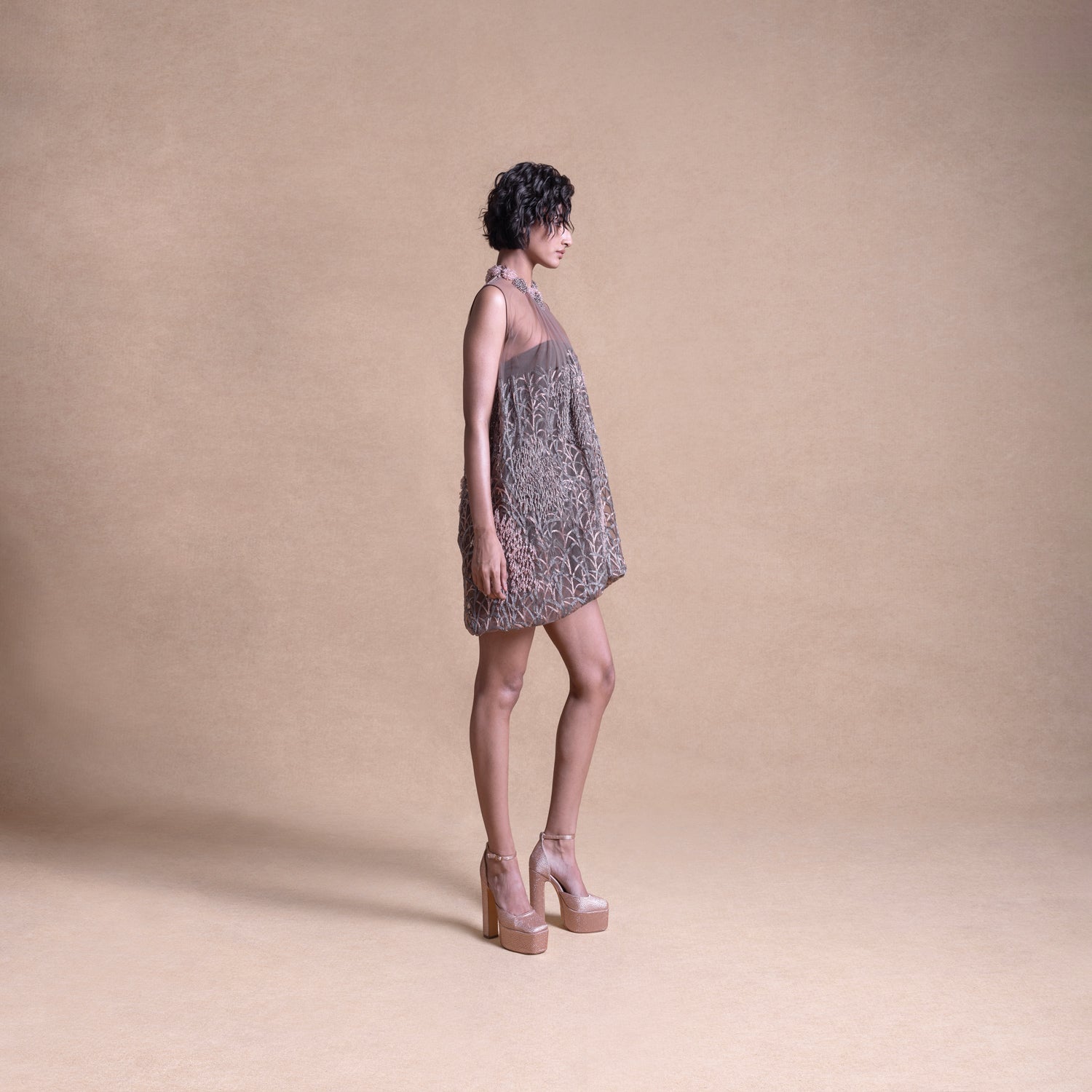 Side view of a model wearing a loose, sheer balloon dress - artistic high fashion outfit, youngester dress, luxury womenswear