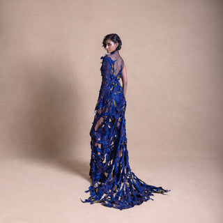 Model posing with her back, electric blue mesh gown, one-sleeve design - red carpet couture gown, cocktail gown, asymmetric dress