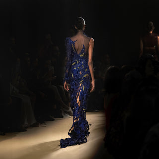 Back view of model wearing an asymmetrical electric blue couture gown with sheer detailing -  asymmetrical dress, sheer couture, red carpet couture gown, cocktail gown