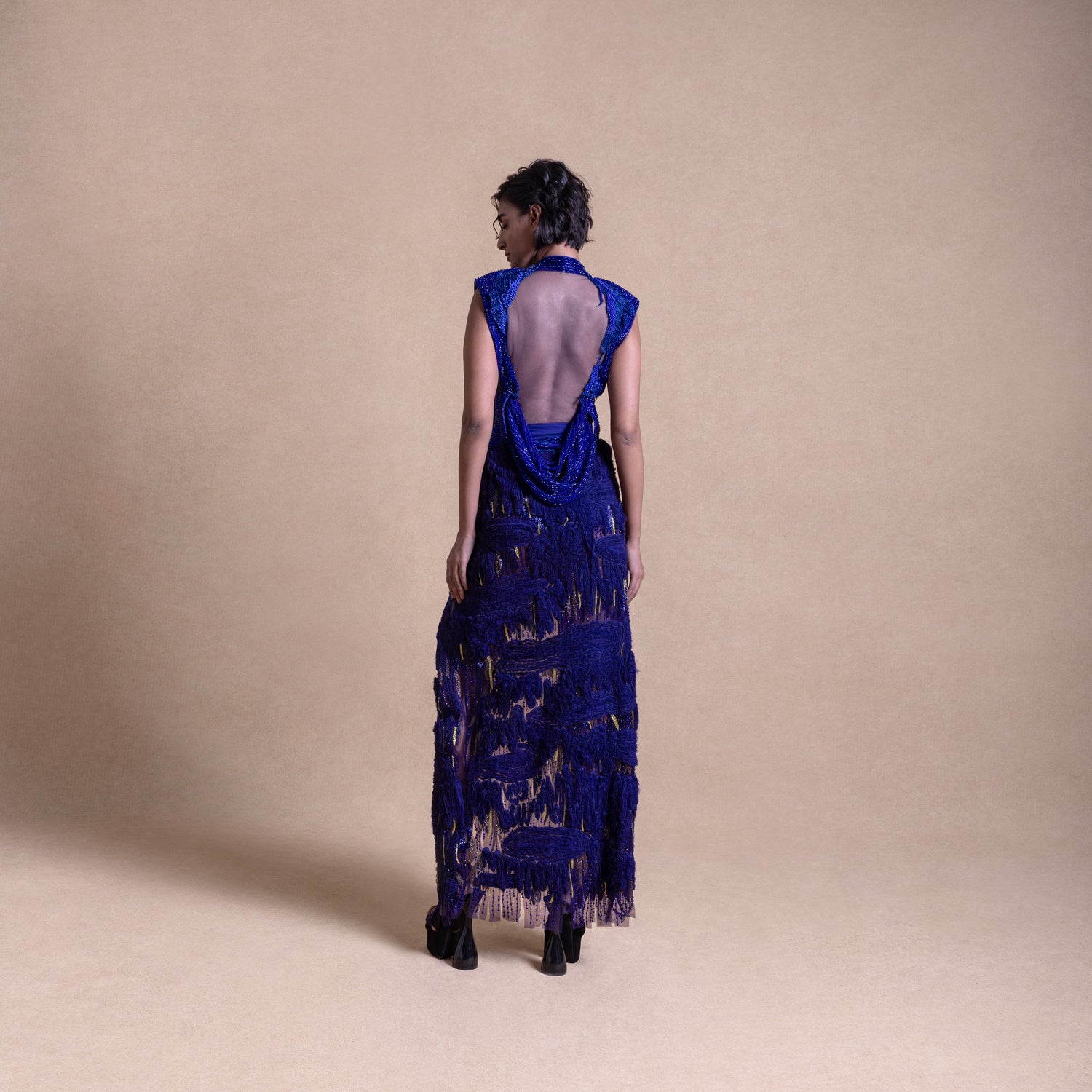Back view of royal blue couture gown with sheer panel and draped detailing – designer evening fashion, elegant eveningwear, redcarpet look