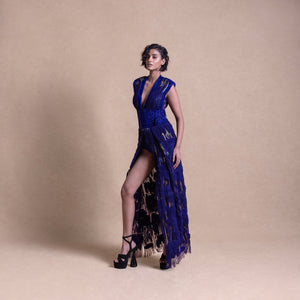 Elegant model in royal blue slit gown with sculpted shoulders and fringe details – high fashion eveningwear look, bold runway style
