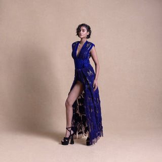 Elegant model in royal blue slit gown with sculpted shoulders and fringe details – high fashion eveningwear look, bold runway style