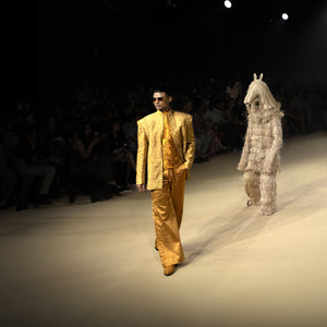 Male model in metallic gold textured Bandhgala tuxedo with embellished shirt and flared trousers walking runway at fashion show - Tuxedo, retro suit, menswear