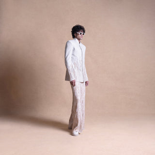 Model in handloom Bandhgala jacket and trousers with embellishments against beige background – artisanal men’s fashion, men's jacket