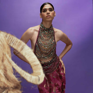 Model in crystal-embellished halter top and cut-out magenta skirt,  backless top paired with embellished skirt – bold luxury look, redcarpet jewelled top and skirt, couture jeweled outfit