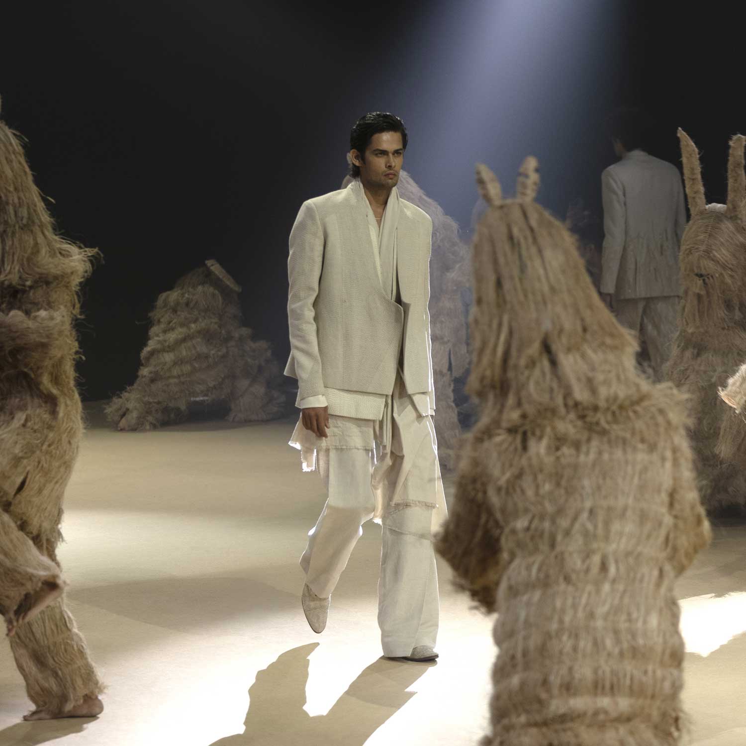 Runway model in layered angrakha-inspired white jacket set with kantha embroidery – mens couture, heritage-inspired