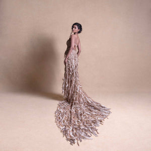 Model in Structured corset with 3D embellished trail skirt, posing with back turned -  high fashion model, redcarpet cocktail gown