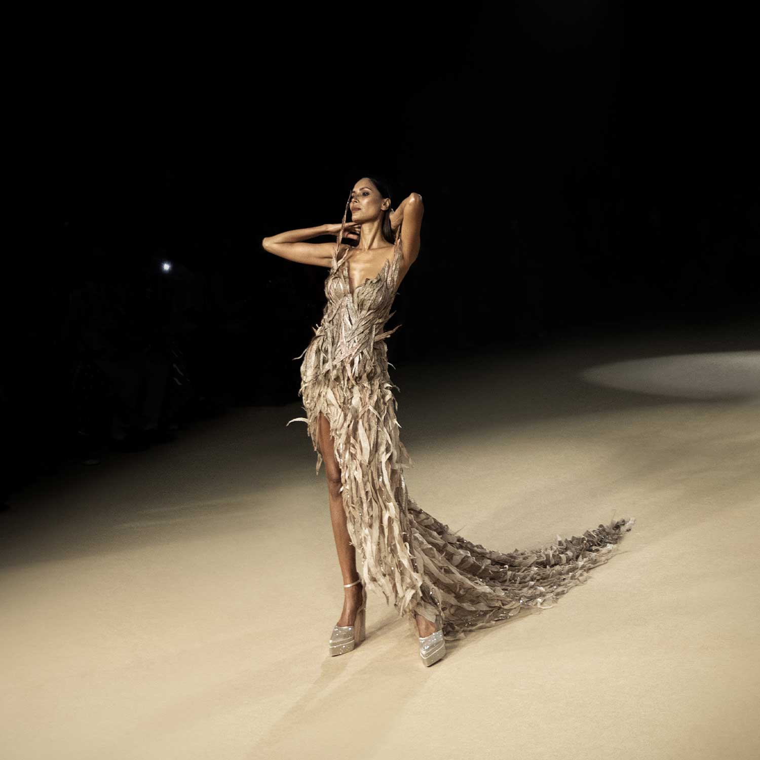 Runway model in corset dress with high slit and feathered trail - futuristic couture ensemble. redcarpet cocktail gown, futuristic red carpet dress