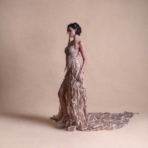 Side profile of model in Structured 
 gown with high slit and textured trail - futuristic couture ensemble. redcarpet cocktail gown