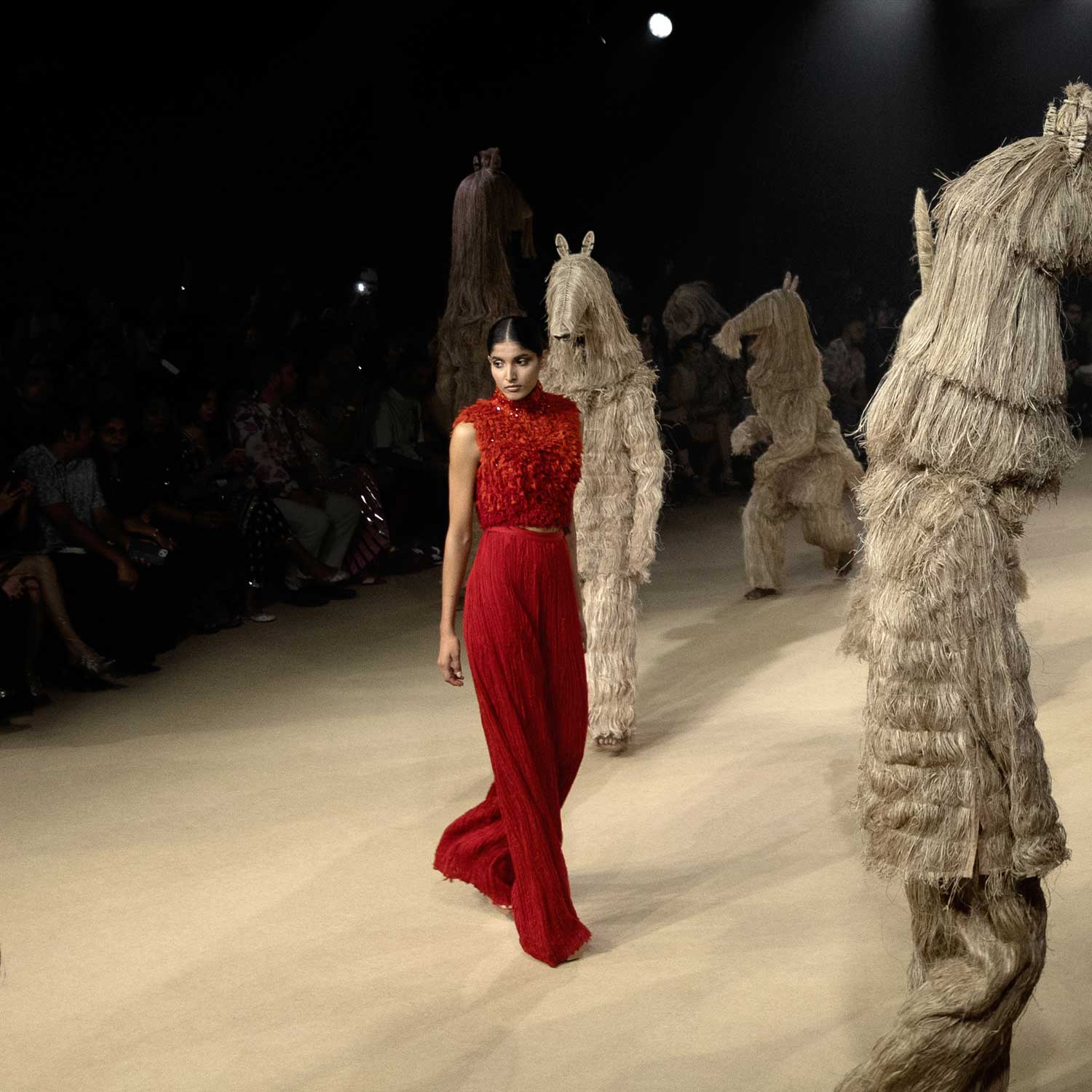 Runway look featuring a red ombre high-neck crop top with rich texture and matching wide-legged flared chiffon pants -  lightweight modern silhouette, jumpsuit