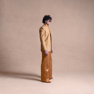 Model in profile wearing a gold Bandhgala suit with matching wide-leg trousers - Tuxedo, retro suit, menswear