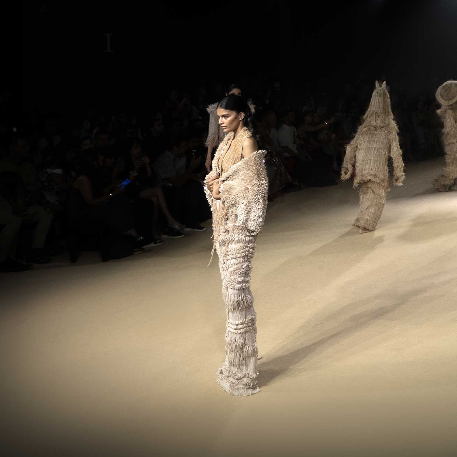 Backless dress with drip string design and textured cape – contemporary runway look