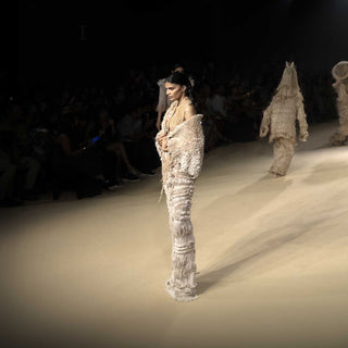 Backless dress with drip string design and textured cape – contemporary runway look