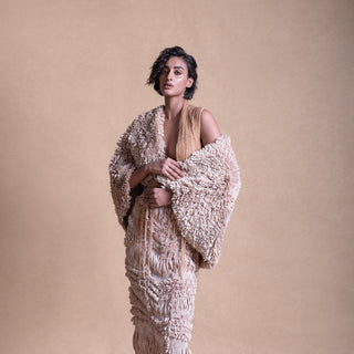 Backless dress with textured cape and intricate string details – contemporary fashion portrait, avant-garde style