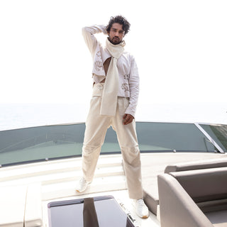 Men's lightweight ivory cutwork jacket paired with pleated pants and scarf – relaxed co-ord for summer getaways and casual elegance