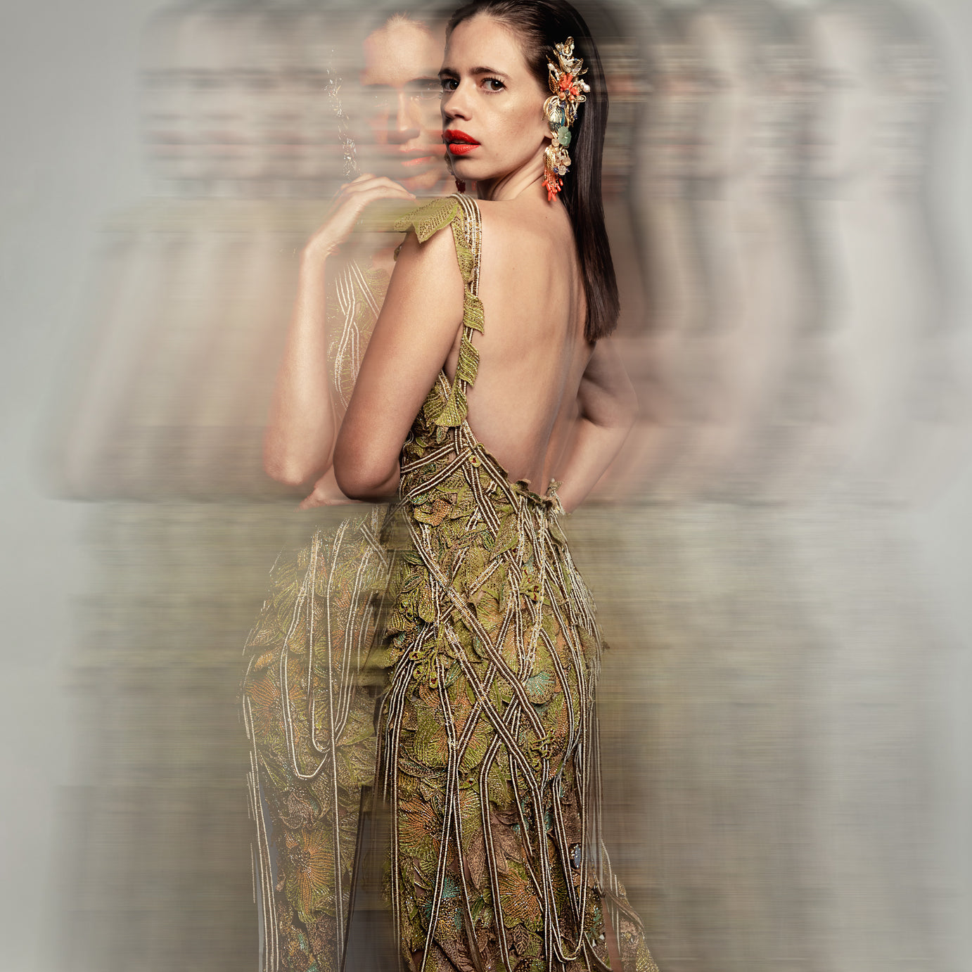 Back view of Women's moss green embellished gown with open back and beaded fringe – elegant reception couture