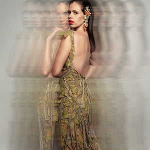Back view of Women's moss green embellished gown with open back and beaded fringe – elegant reception couture