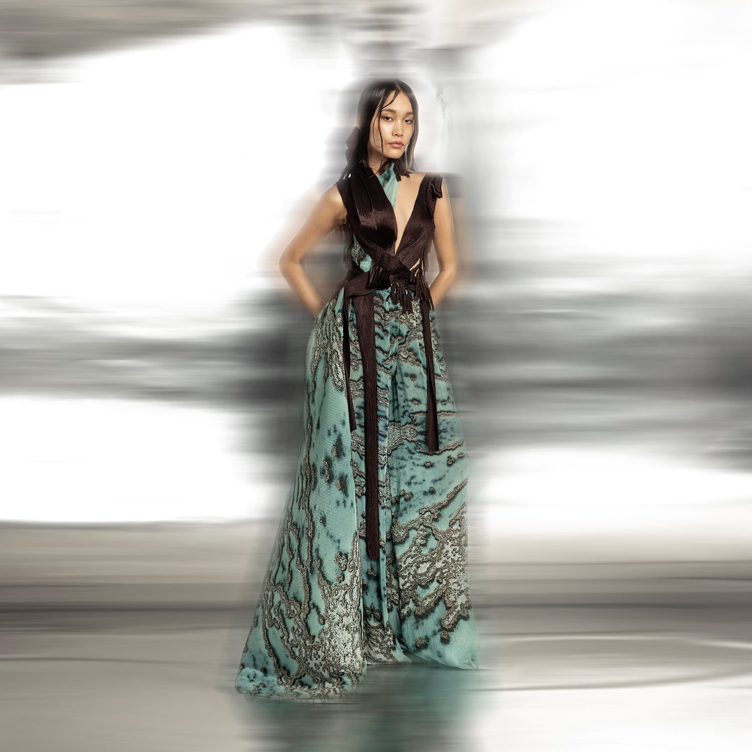 front view of Women's reef printed jumpsuit with sculpted brown bodice and flowing wide-leg drape – modern couture piece with raised neckline