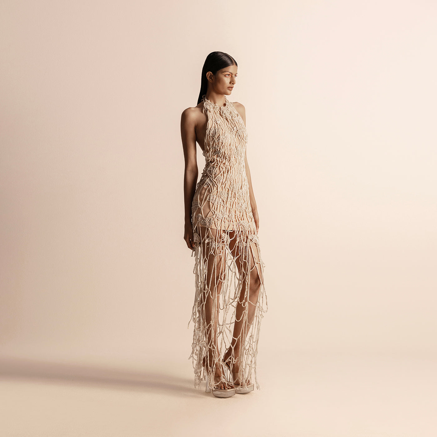 Side view of halter neck drip string gown with sculpted fit and sheer paneling – avant-garde, drip string gown, halter neck dress, designer eveningwear