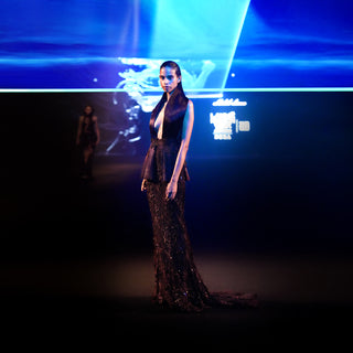 Women's couture gown with structured collar and shimmering trail – dramatic red carpet evening wear
