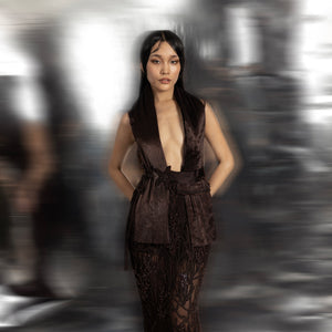 Women's deep brown gown with exaggerated collar and beaded sheer skirt – red carpet couture ensemble