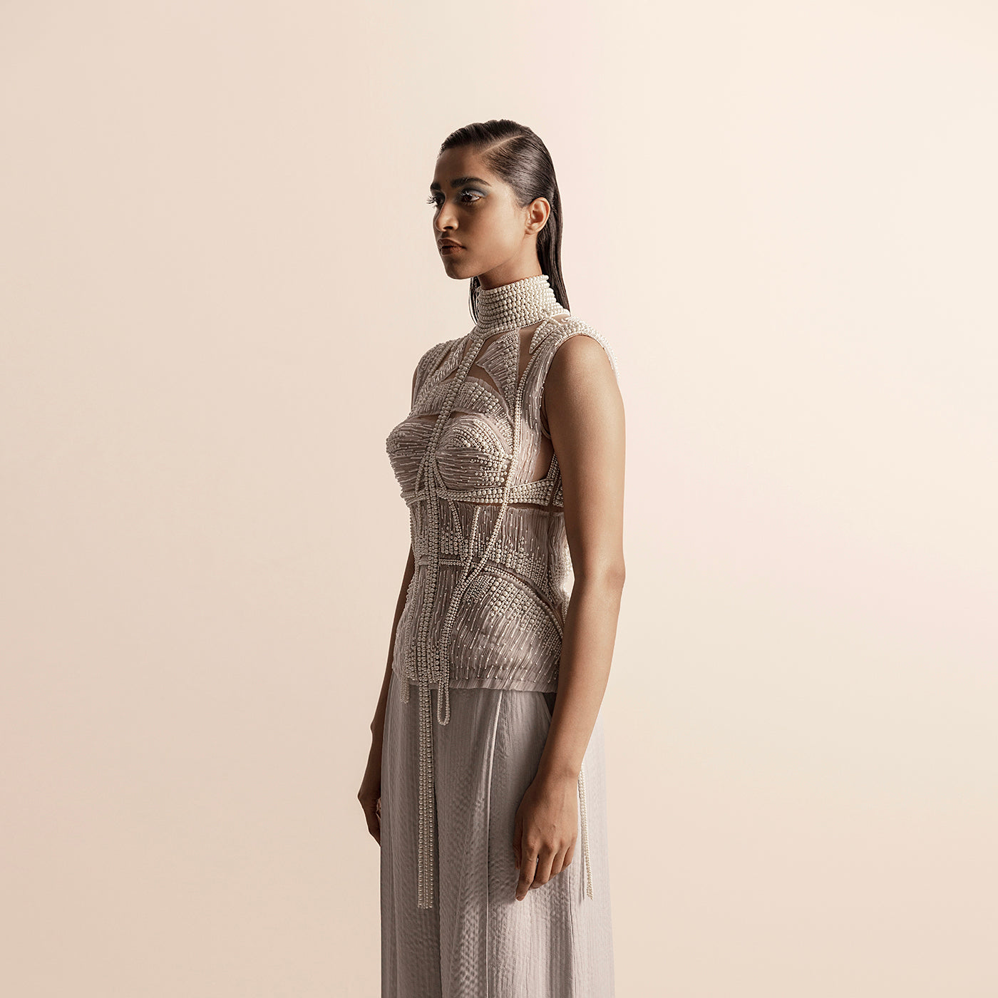 Side view of Fluted pearl embellished high collar top with sheer paneling and quilted chiffon trousers –  high collar blouse, sheer couture, chiffon trousers, designer coordinated look
