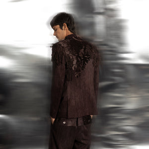 back view of Grouper cocktail jacket with back fringe and yarn couching embroidery – statement menswear with dark artisanal detailing