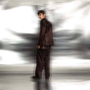 full back view of Grouper open chest jacket with graphic yarn couching at back – formal menswear with fringe detailing and relaxed trousers