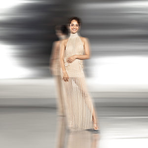 full shot of pleated high-neck gown with sheer finish and delicate side embellishments – modern minimalist evening look, high-neck pleated gown