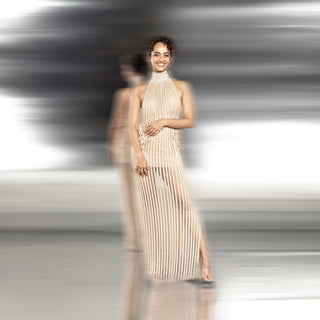 full shot of pleated high-neck gown with sheer finish and delicate side embellishments – modern minimalist evening look, high-neck pleated gown