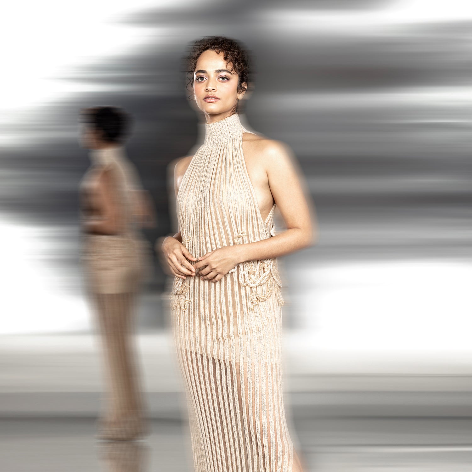 upperbody shot of Women's nude high-neck shift gown with vertical pleats and side embroidery – minimal modern couture silhouette
