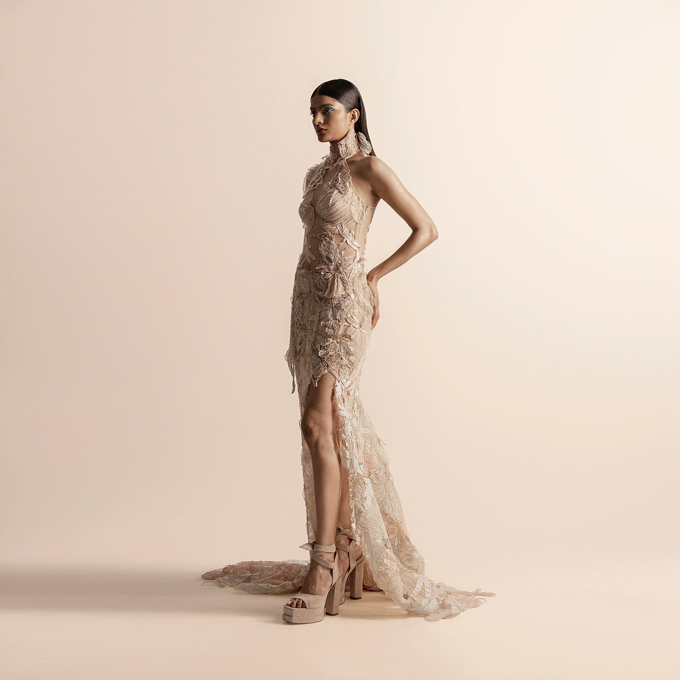 Side view of high halter neck embellished gown with high slit and trail – showstopper evening wear, reception gown, formal side view