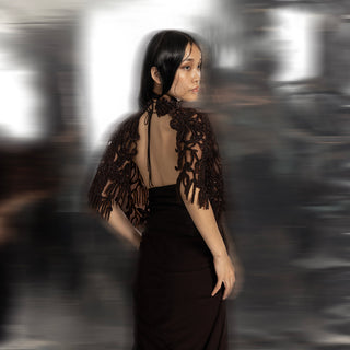 back view of Women's open-back black saree with reef-inspired 3D cape – artistic evening fusion ensemble