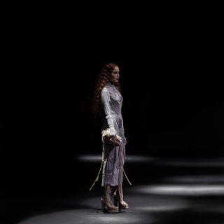 full side shot of Women's sculpted midi dress with full sleeves and tassel clutch – sleek designer runway look for party events