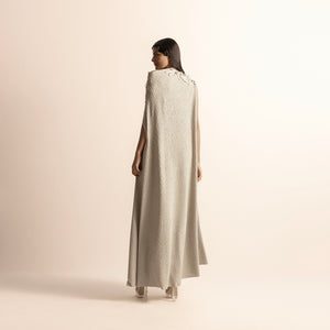 back view of Women's full-length knit gown with cape-style back and subtle shoulder embroidery – fluid and elegant draped design