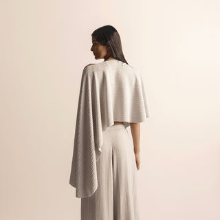 back close-up of Women's taupe knit cape crop top with asymmetric back drape and high-waisted quilted pants - creative Indo-western ensemble