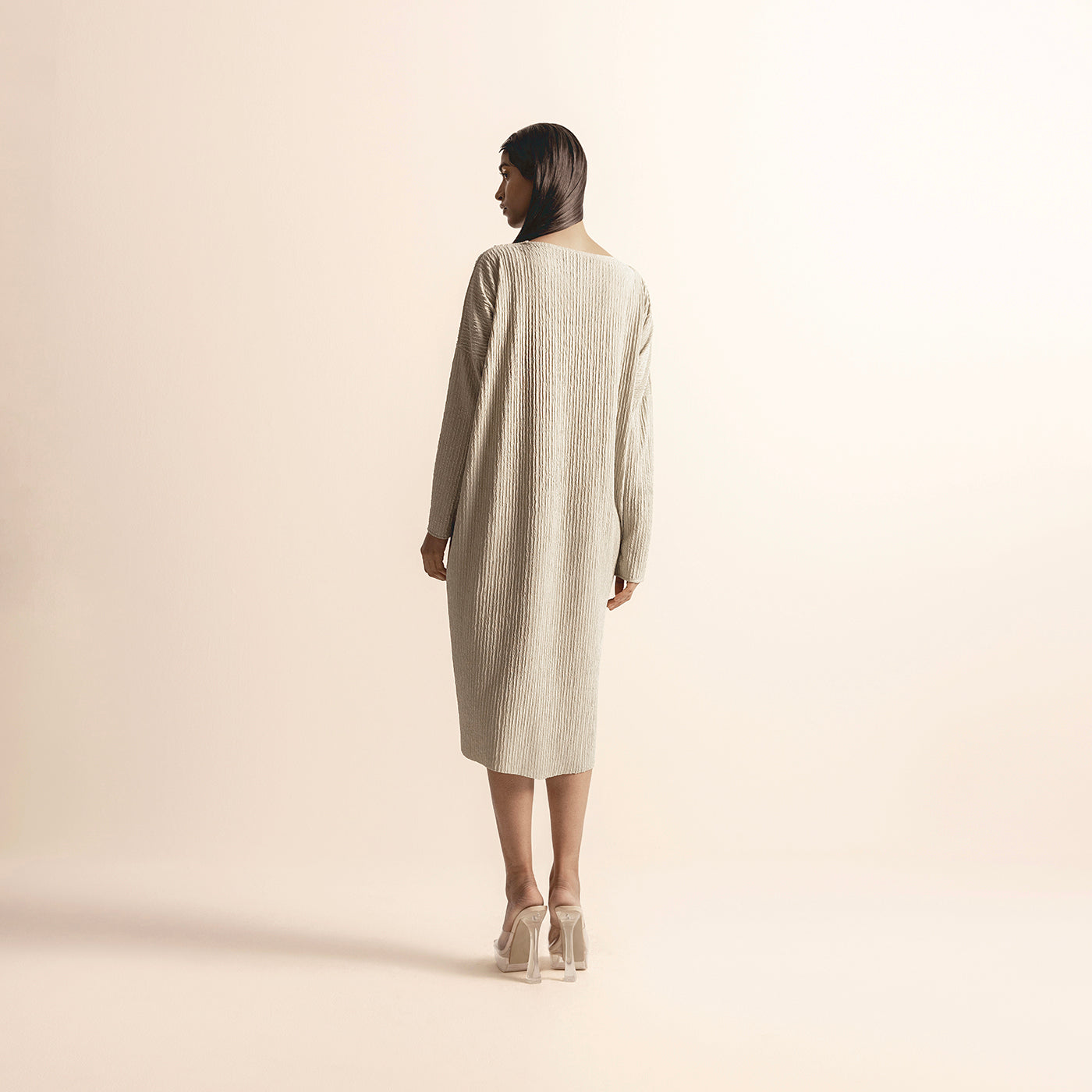 back view of Women's  knit dress with full-length sleeves and clean back silhouette – minimalist handcrafted look, minimalist design, full sleeves, handcrafted knitwear, neutral tone