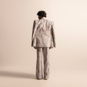 Back view of Nadru printed men's suit with wide-leg trousers and sharp-shouldered blazer, statement blazer, artistic tailoring